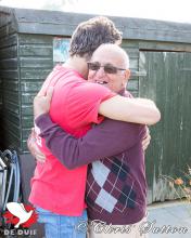 Kevin and John hugging.